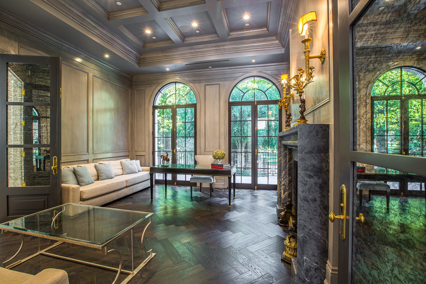 Elegant formal salon with marble fireplace and French doors inside a luxury Los Angeles estate rental.