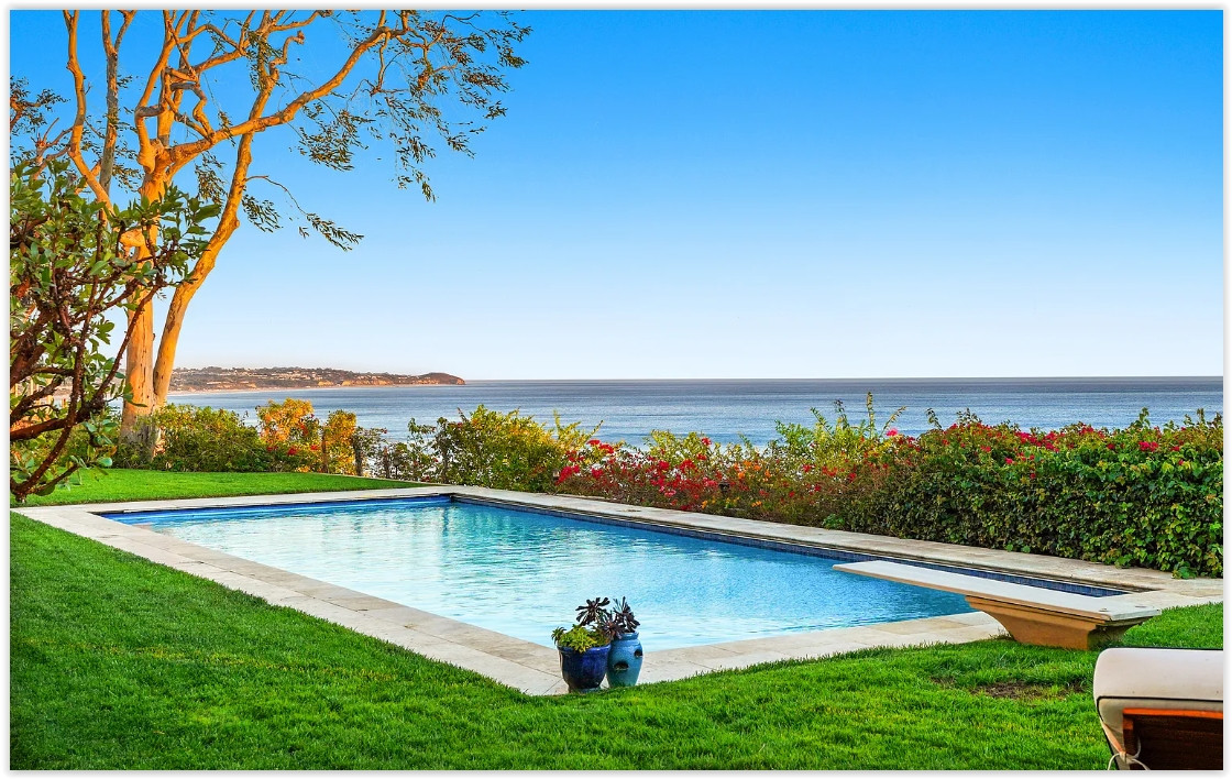 Swimming pool with panoramic Pacific Ocean views at an elegant Malibu private estate.