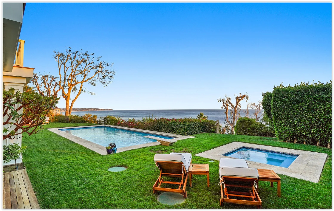 Swimming pool with panoramic Pacific Ocean views at an elegant Malibu private estate.