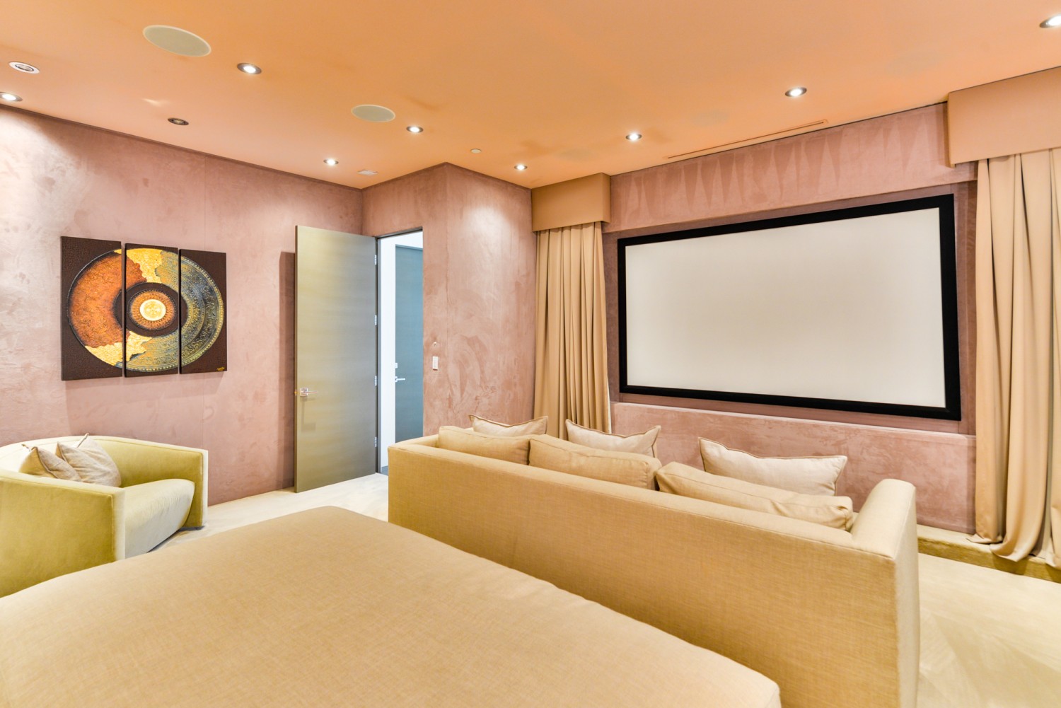 Luxury private home theater with plush seating and a large projection screen inside a modern Bel Air estate.