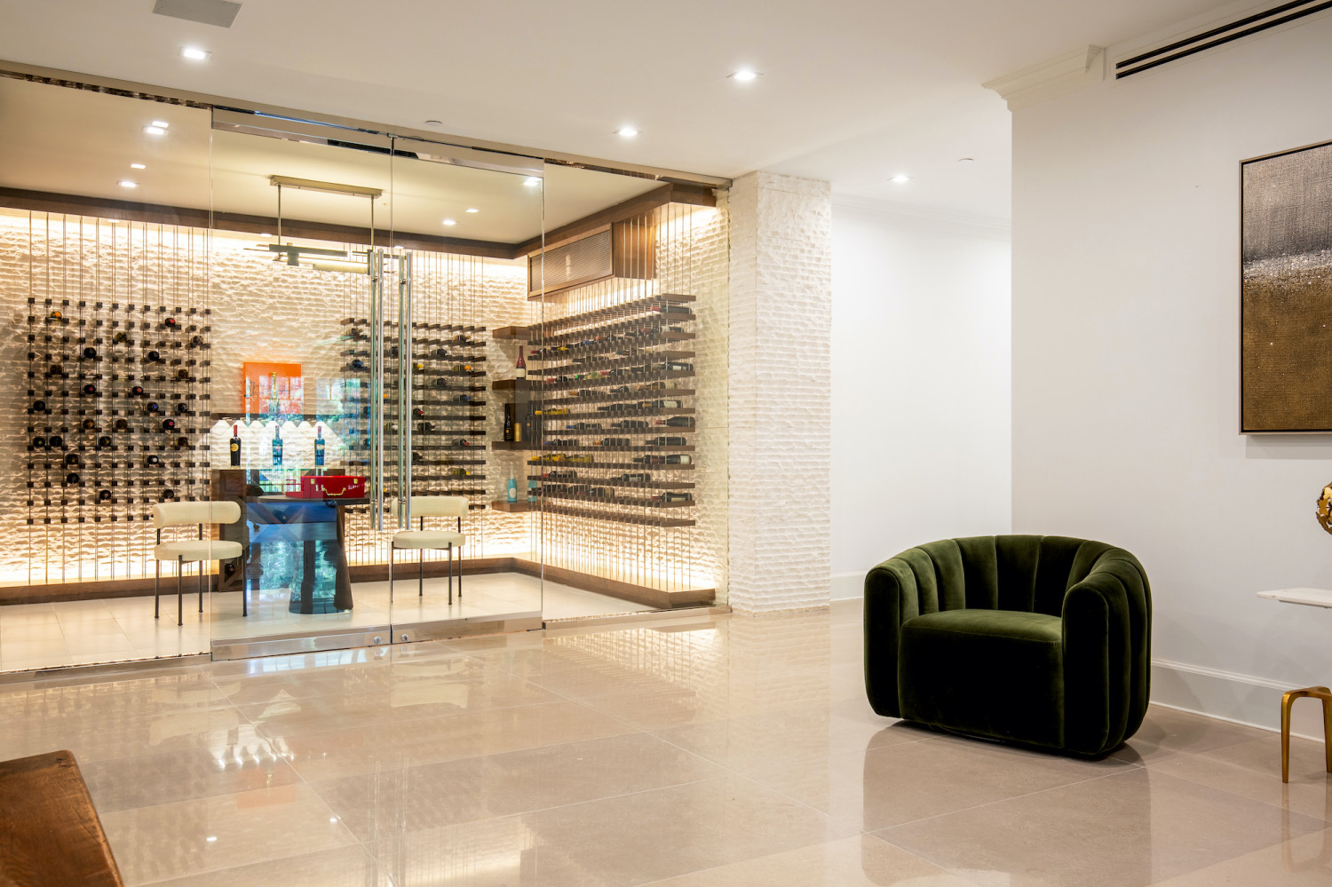 Custom glass wine room with illuminated display walls inside a Modern Private Estate Home Events estate.