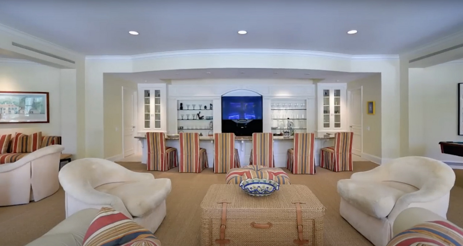 Spacious entertainment lounge with built-in bar seating inside a luxury Bel Air estate.