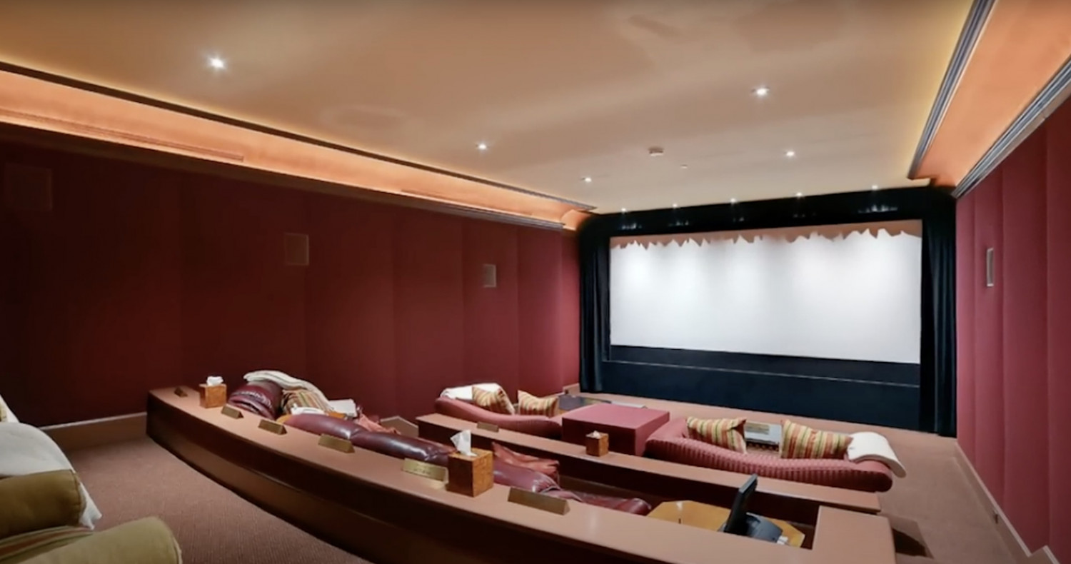 Luxury private theater with tiered seating and projection screen inside a Bel Air estate.