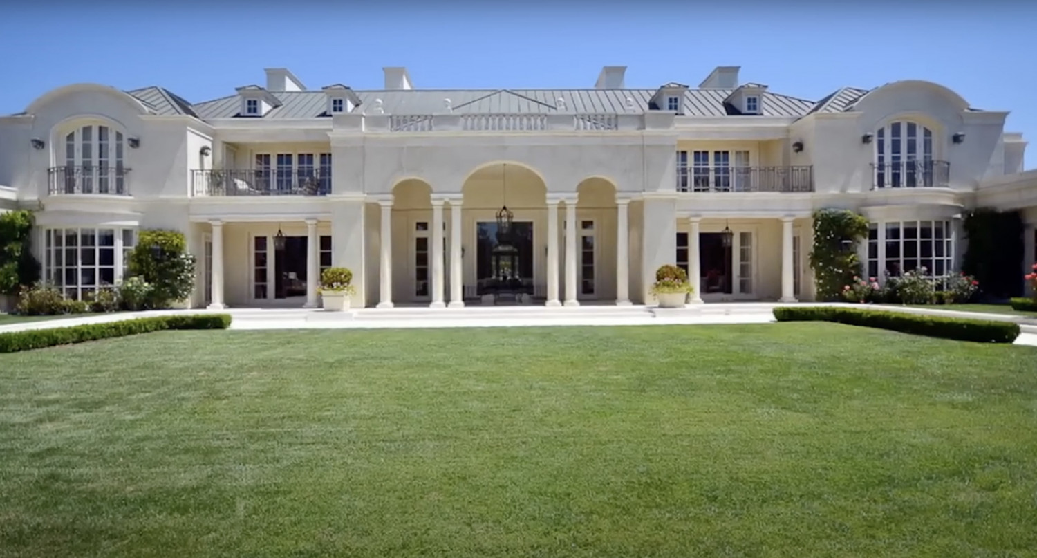 Grand rear elevation of a French-inspired Bel Air estate featuring terraces, columns, and landscaped grounds.